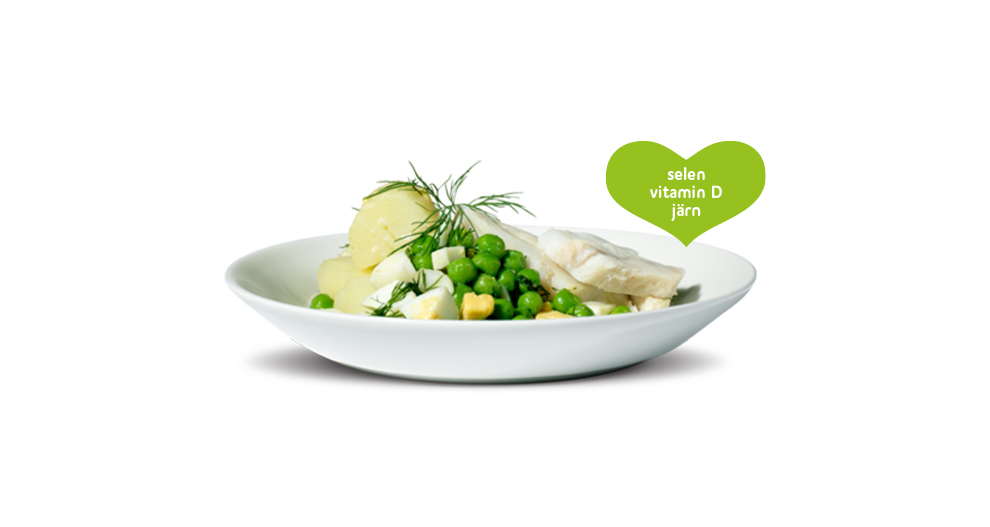 En matskål med gröna ärtor, kokta ägg och fisk, tillsammans med en hjärtformad etikett med text.